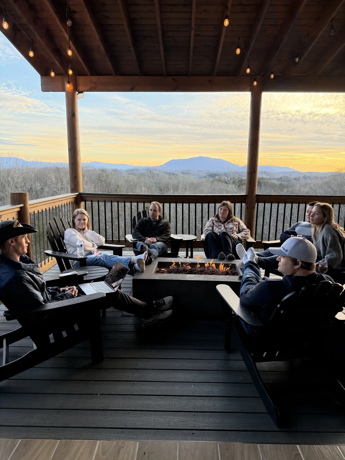 The Charter Connect team around a fire pit overlooking the Smoky Mountains